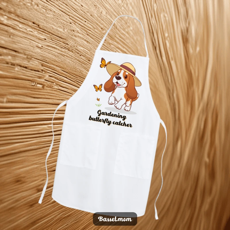 Funny Basset Hound apron showing a dog in a sun hat playfully chasing a butterfly, perfect for kitchen or garden fun.