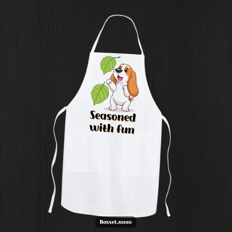 Funny Basset Hound apron, showing a dog playfully trying to catch a large falling leaf, a humorous kitchen assistant.