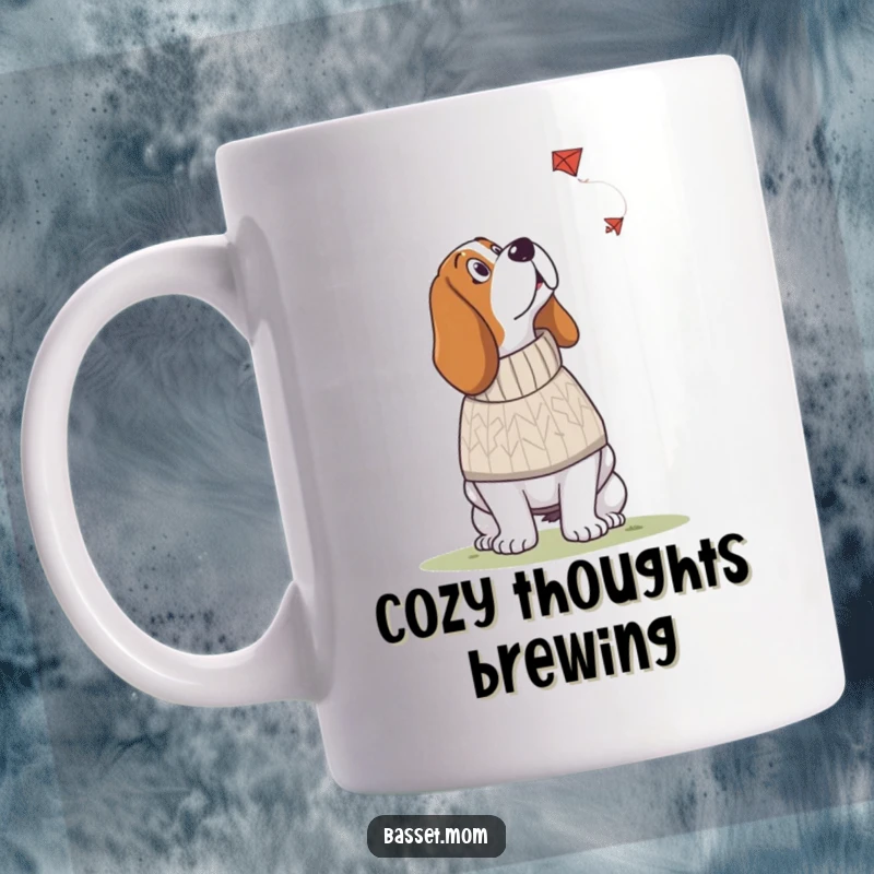 Funny Basset Hound mug showing a dog in a knitted sweater looking up at a kite, embodying cozy curiosity and wonder.