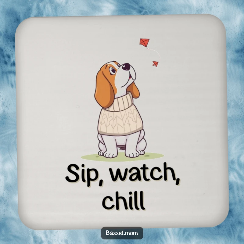 Funny Basset Hound coaster featuring a dog in a knitted sweater looking up at a kite, adding cozy humor and surface protection.