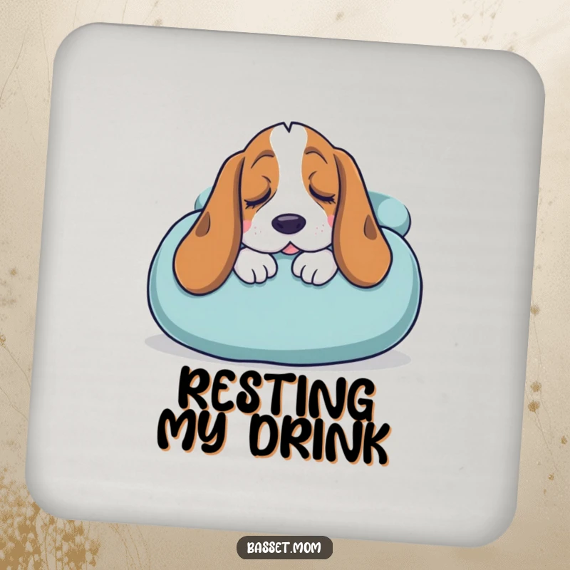 Funny Basset Hound coaster featuring a sleepy dog snuggling into a giant cushion, adding cozy humor and surface protection.