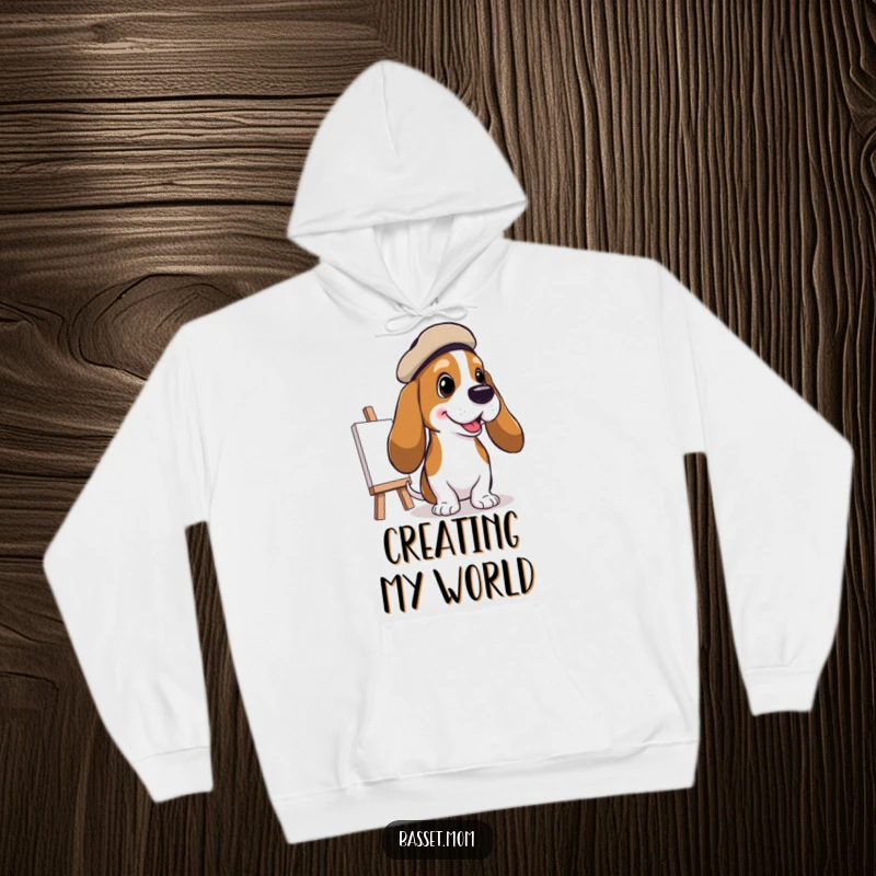 Funny Basset Hound Artist Hoodie: A Basset hound in a beret painting a cheerful picture, offering warmth and artistic inspiration, funny gift.