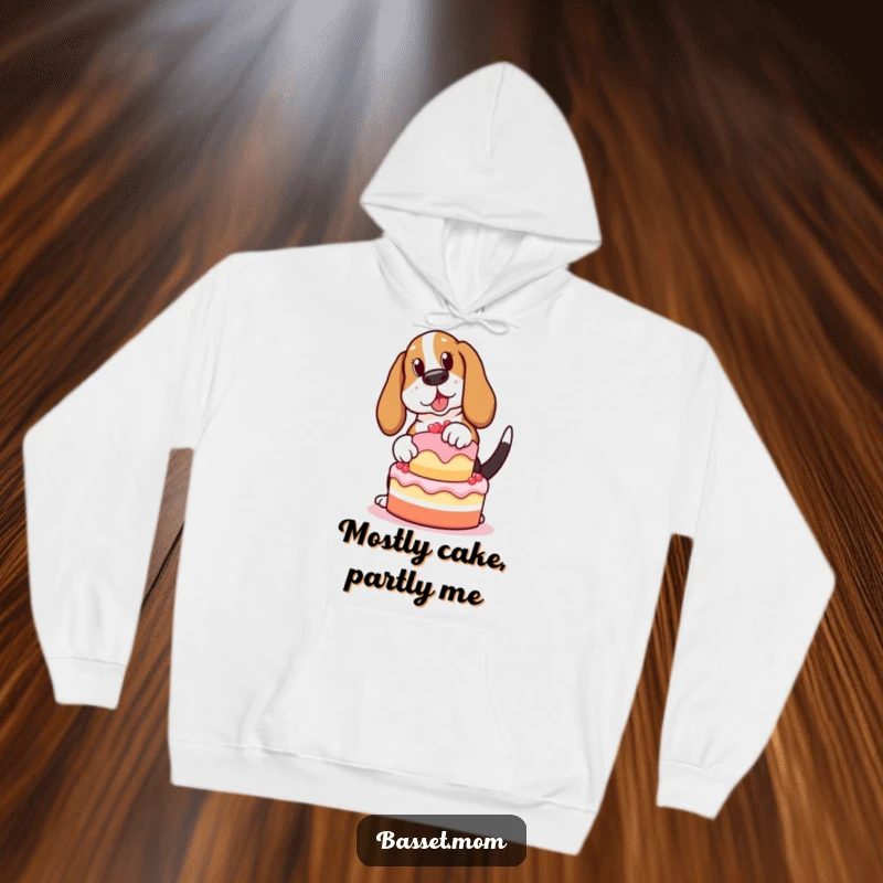 Funny Basset Hound hoodie, a cute doggy attempting to balance a cake with a wagging tail, ideal for a humorous gift.