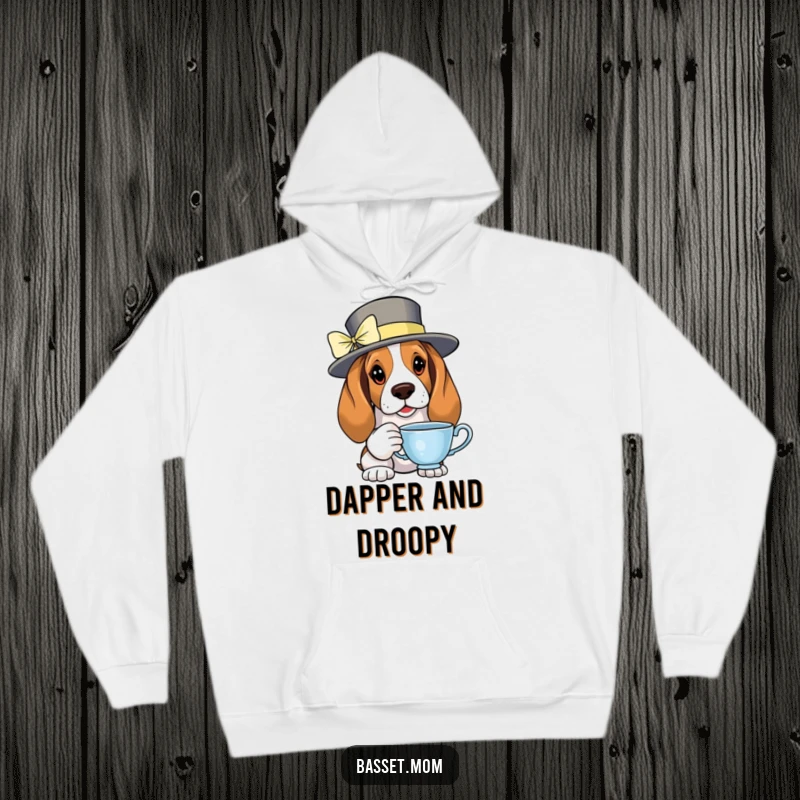Funny Basset Hound wearing a fancy hat and holding a teacup, exuding elegance on a warm hoodie.