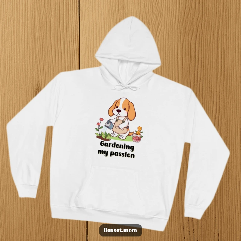 Funny Basset Hound hoodie depicting a dog in a gardening apron watering a flower, offering warmth and horticultural humor.
