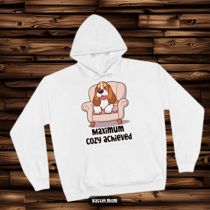 Funny Basset Hound hoodie, with a happy sigh, lounging on a cushioned chair, offering the perfect blend of comfort and humor.