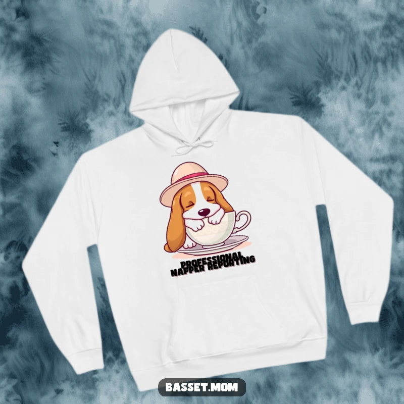 Funny Basset Hound hoodie showcasing a hound in a large hat napping soundly near a teacup, ideal for ultimate relaxation and warmth.