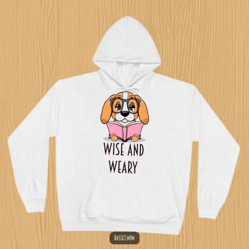 Funny Basset Hound hoodie depicting a dog with glasses contentedly reading a book, ideal for cozy, intellectual downtime.