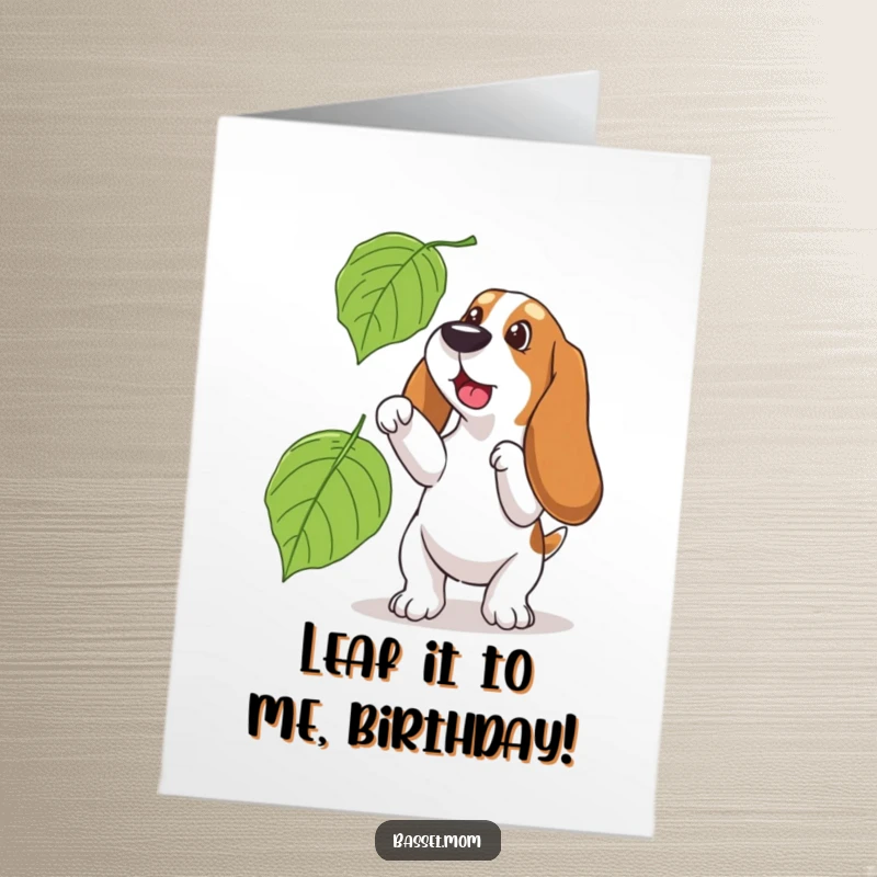 Funny Free Printable Birthday Card - A Basset Hound joyfully leaping to catch a giant falling autumn leaf.