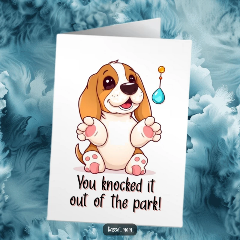 Funny Free Printable Congratulations Card: A Basset Hound playfully bats at a dangling jewel with its paws up, celebrating a win.
