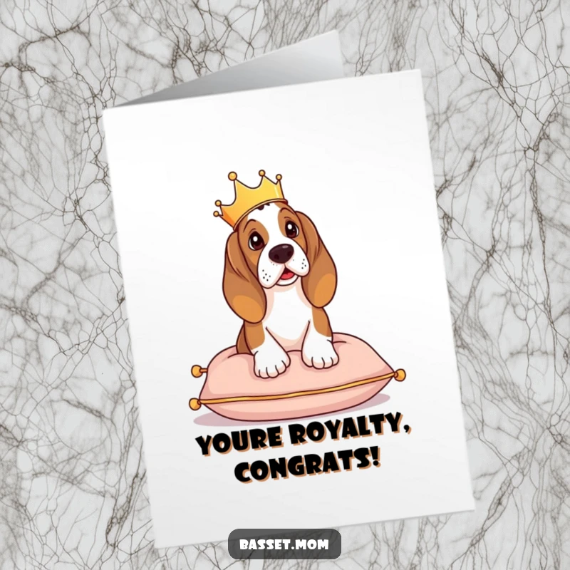 Funny free printable congratulations card depicting a Basset Hound with a small crown, surveying its surroundings from a plush cushion.