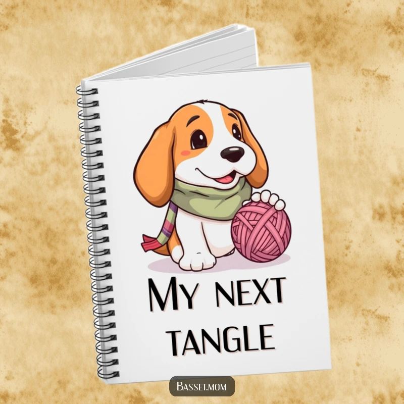 Funny Basset Hound notebook, a dog wearing a scarf, playfully batting a yarn ball, inspiring creative thoughts.
