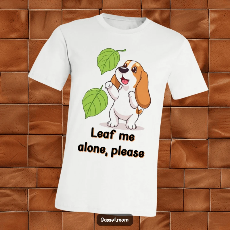 Funny Basset Hound t-shirt, depicting a dog playfully leaping to catch a big falling leaf in an autumn setting.