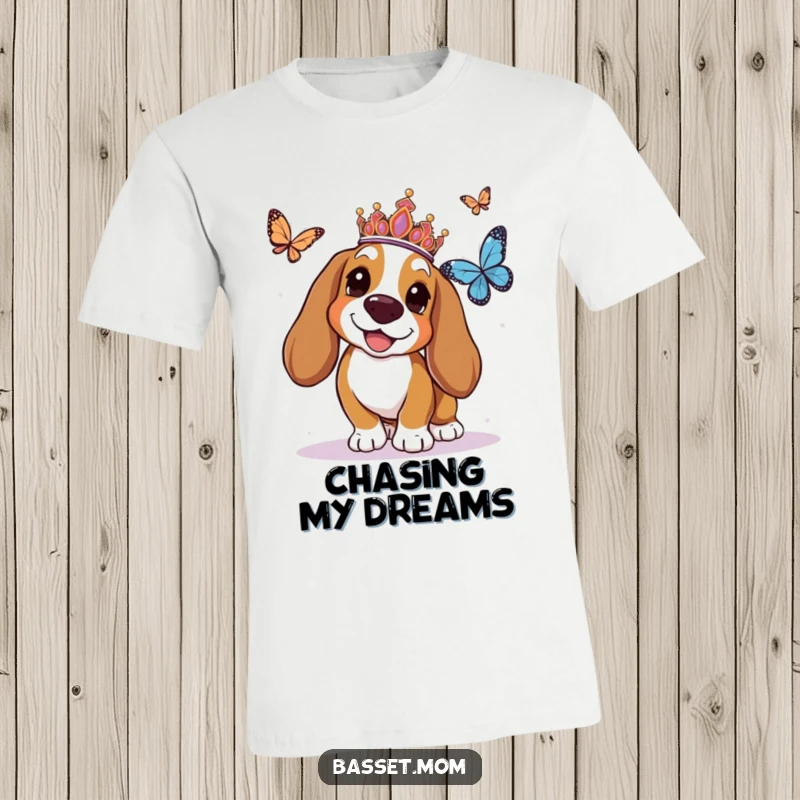 Funny Basset Hound t-shirt featuring a tiara-wearing dog ecstatically chasing a butterfly, embodying playful royalty and carefree fun.