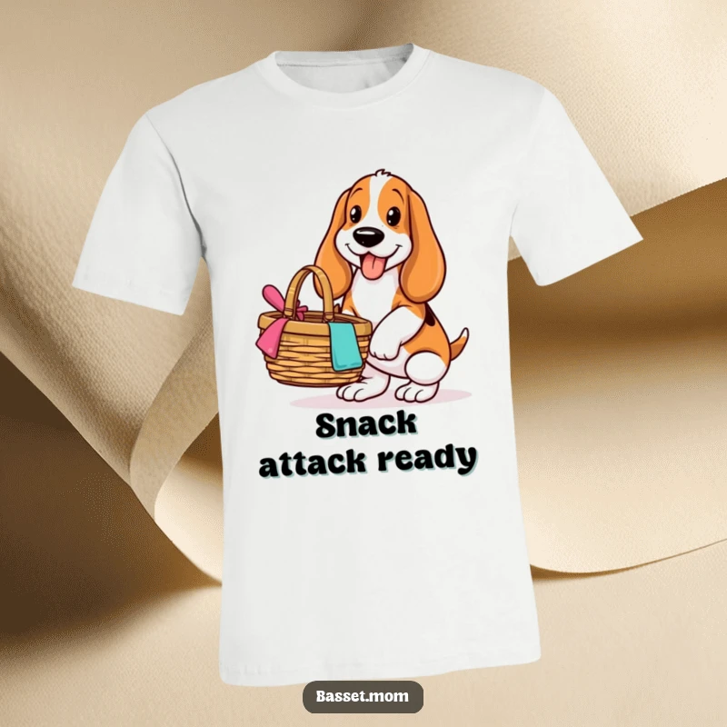 Funny Basset Hound t-shirt, depicting a dog with a joyful face balancing a picnic basket, set for an outdoor meal.