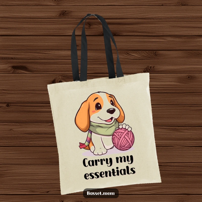 Funny Basset Hound tote bag, a dog with a scarf, mid-playtime, batting at a large ball of yarn with sheer delight.