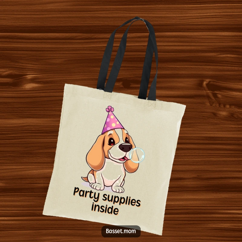 Funny Basset Hound tote bag showing a dog in a party hat blowing a lollipop bubble, a fun accessory for carrying party essentials.